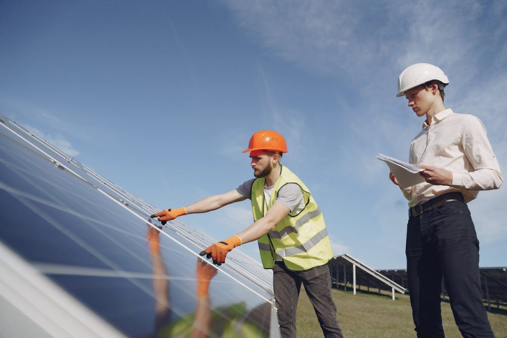 Two engineers examining solar panels, ensuring proper installation and functioning.